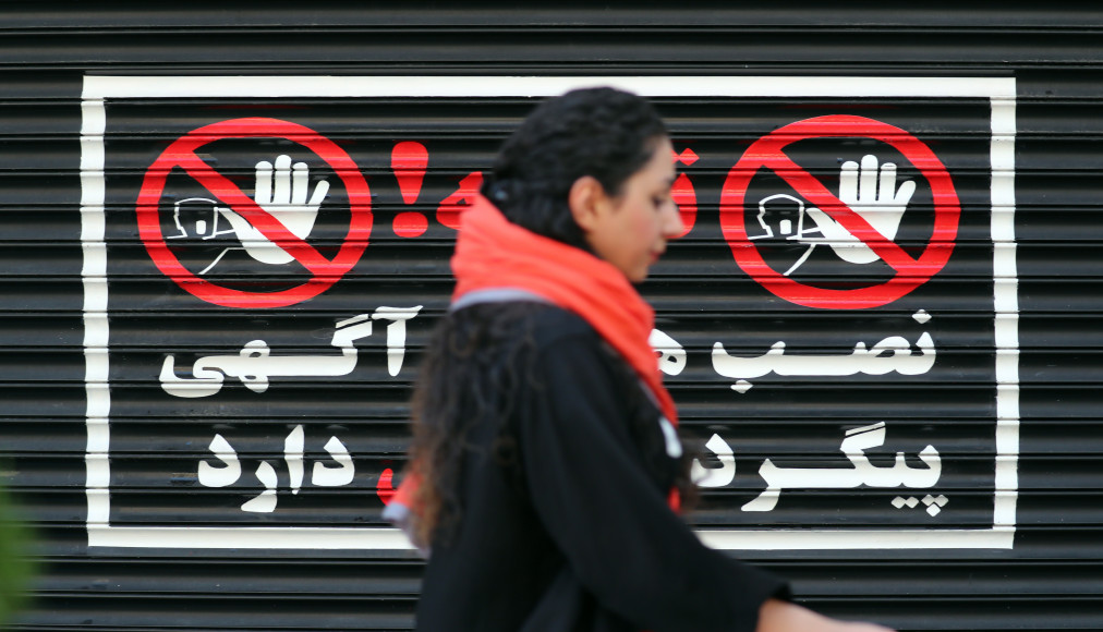 Le 10 août 2023. Une femme iranienne marche devant un magasin fermé de Téhéran, les cheveux au vent / Keystone