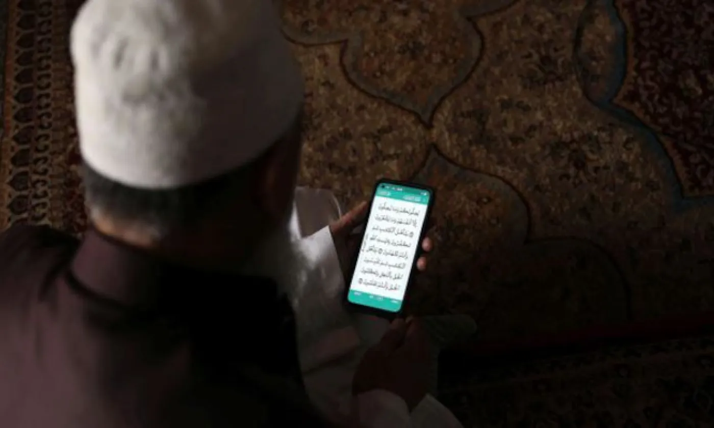 Un Cachemiri musulman récite le Coran sur son téléphone portable lors du premier jour du mois sacré du ramadan (image d'illustration). KEYSTONE - FAROOQ KHAN