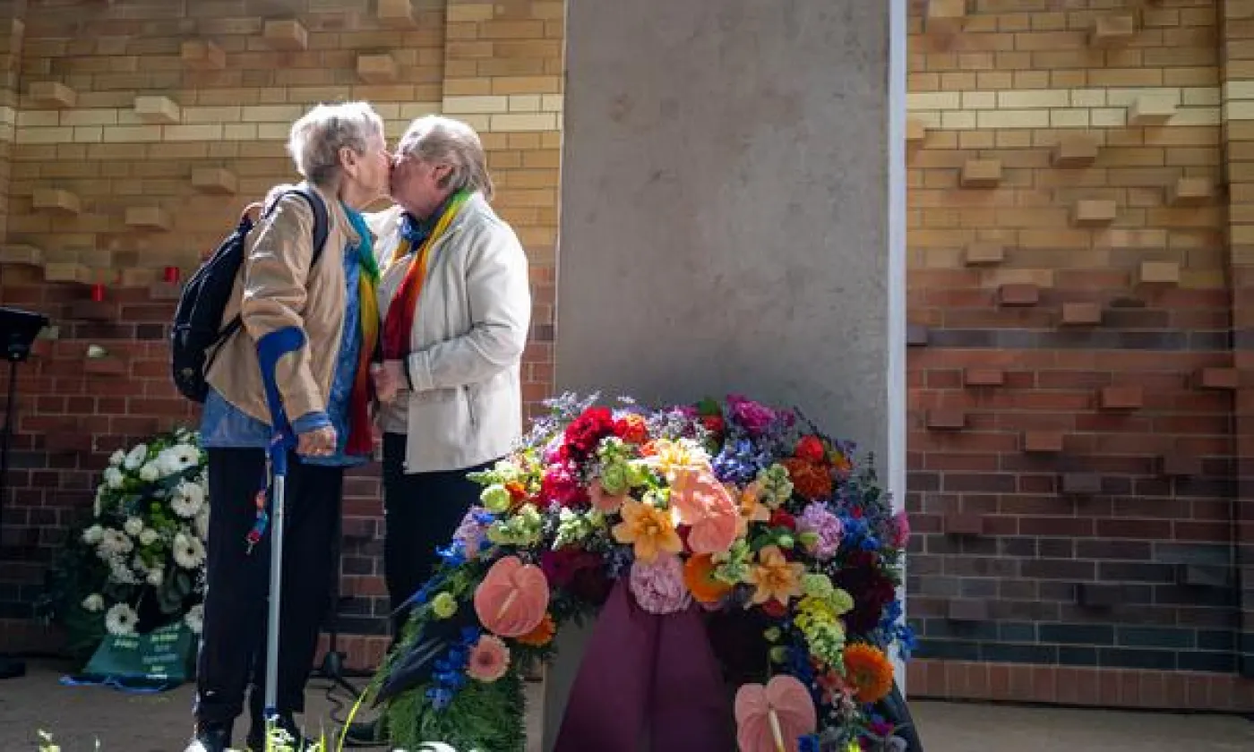 Deux femmes s’embrassent lors de l’inauguration du nouveau cimetière et mémorial dédié aux personnes queer, aménagé par le Schwulenberatung Berlin dans le cimetière St. Matthäus de Berlin. KEYSTONE - FABIAN SOMMER