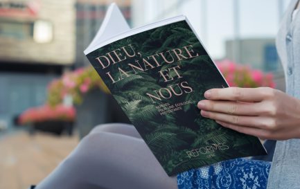 Une lectrice parcourt «Dieu, la nature et nous, Repères pour une écologie protestante» / Photomontage (Eh oui, notre mook est en cours de fabrication) 